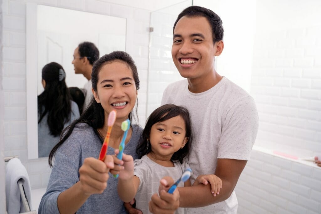 kitchener dentist brushing teeth with family