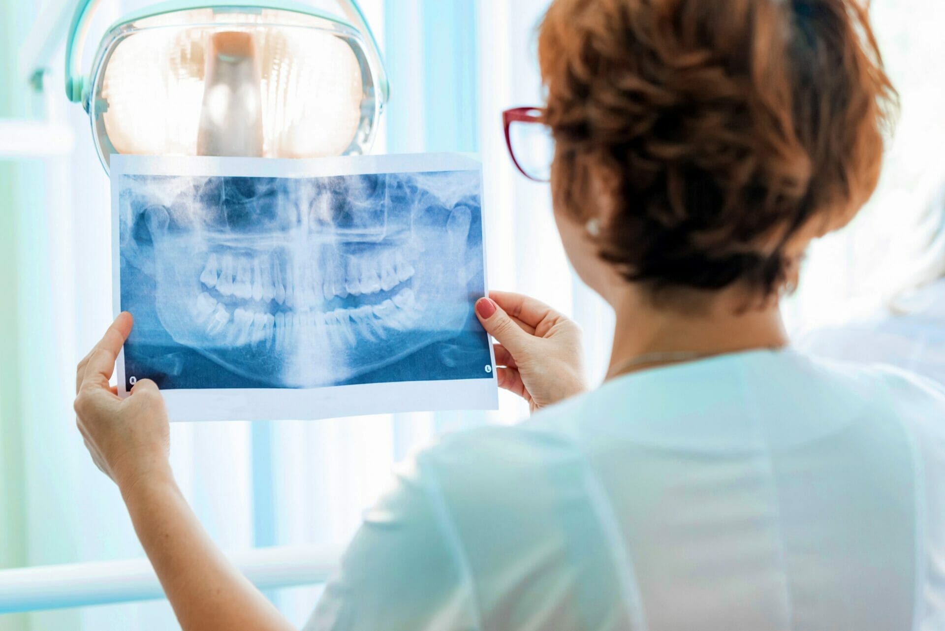 5 Amazing Tips To Help You Find The Right Kitchener Dentist Enamel   FEMALE DENTIST LOOKS AT PAN X RAY Scaled 